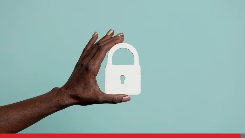 Hand holding a security lock on blue background