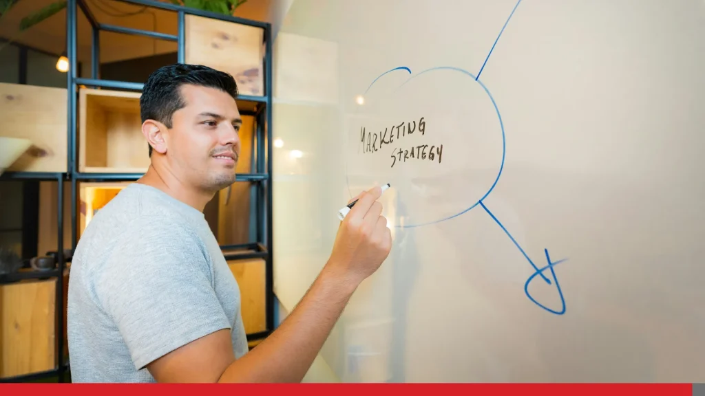 Person developing a marketing strategy on a whiteboard