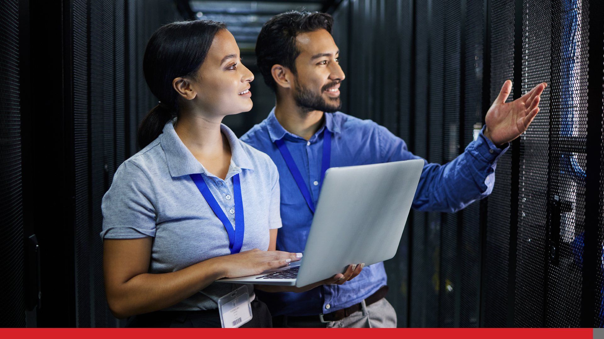 Two people checking out the server room