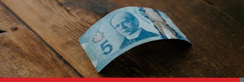 5 dollar Canadian bill on a table.